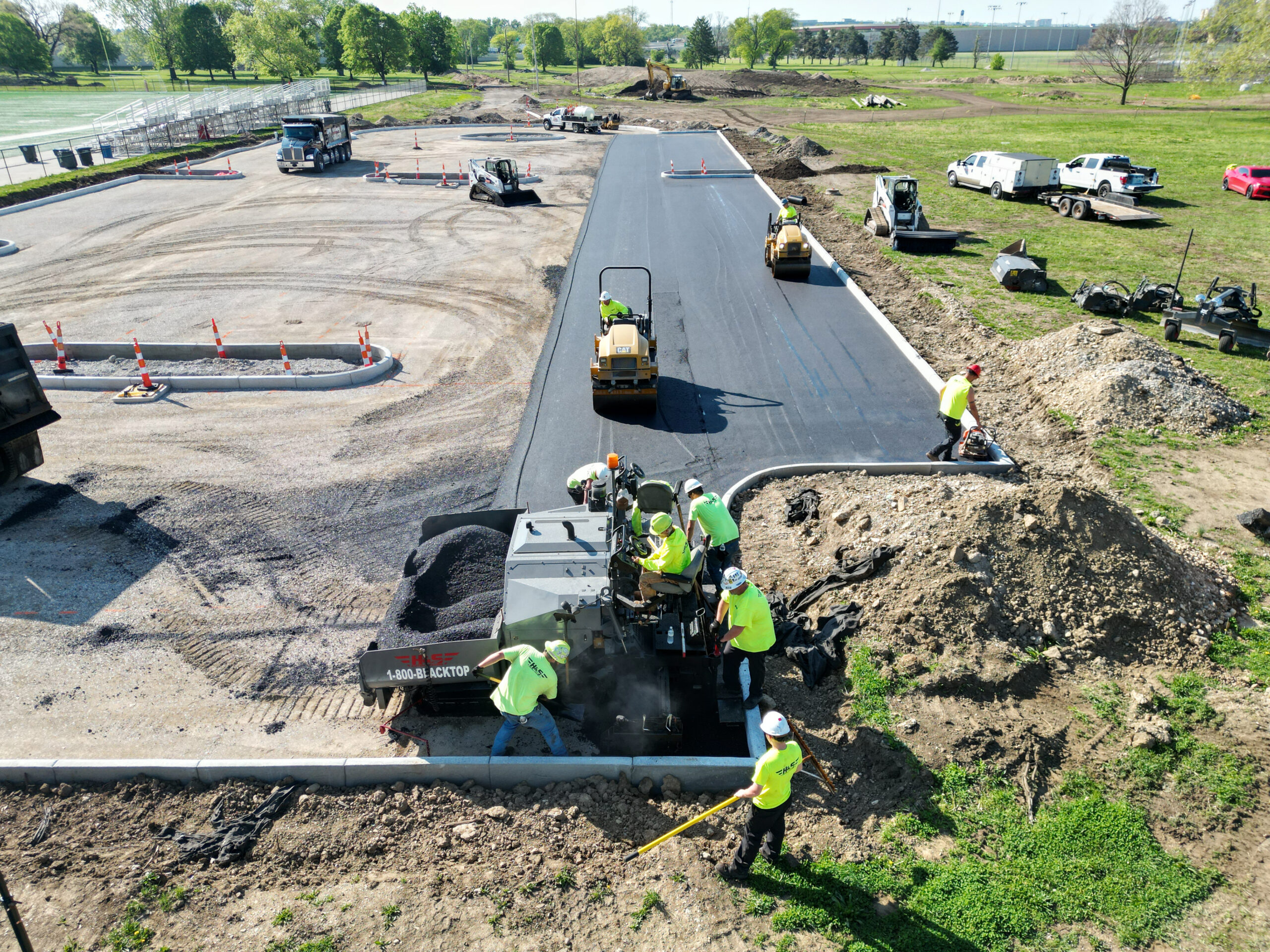 Asphalt Crew utilizing machines to complete a parking lot