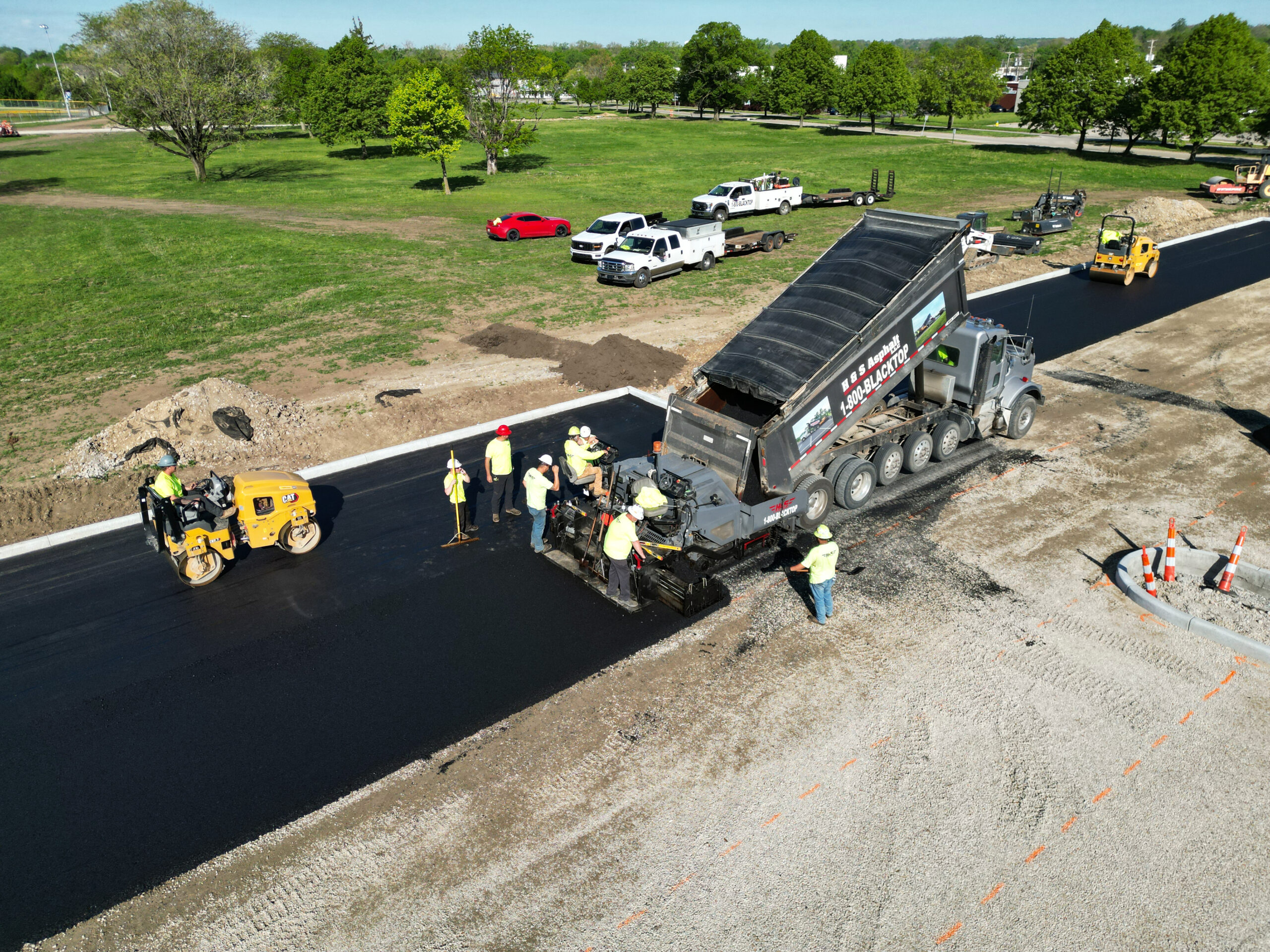 Asphalt crew spreading asphalt after it is poured