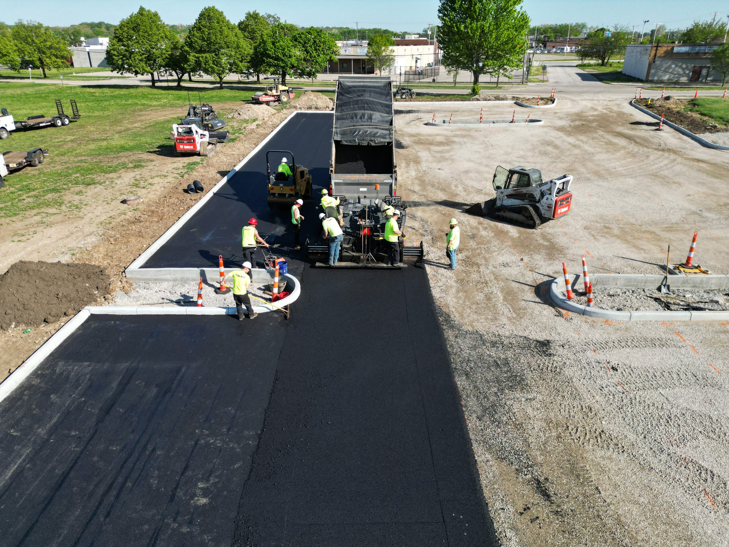 Asphalt crew following an asphalt truck